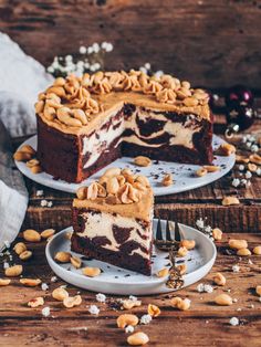 two slices of cake on plates with nuts