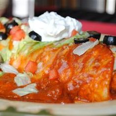 a close up view of a taco salad with lettuce and black olives