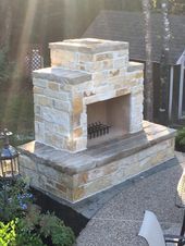 an outdoor fireplace in the middle of a patio