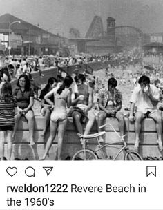 an old black and white photo of people sitting on the beach