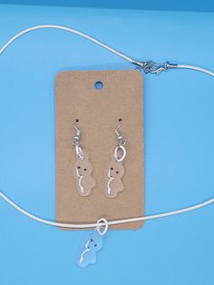 "A cute little 1\" kodama charm on a white cord necklace or silver earring hooks~ Cord necklace: White vinyl cord with a standard lobster clasp and mildly adjustable length. Can be swapped for another color or a chain on request. Dangle earrings: Silver-colored hooks- Lightweight! The hooks I purchased are labeled as hypoallergenic, but did not state what specific metal, so wear with caution." Princess Mononoke Necklace, Totoro Necklace, Princess Mononoke Print, Koala Earrings, Koala Necklace, Princess Mononoke, Frosted Acrylic, Necklace White, Cute Keychain