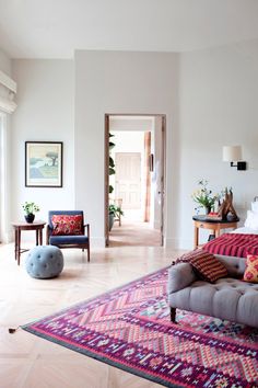 a living room filled with furniture and lots of windows