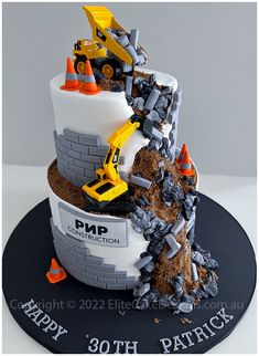 a construction themed birthday cake is on display