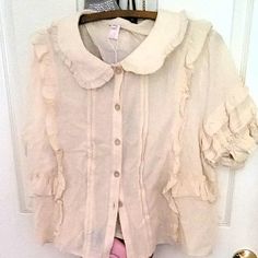 Light Weight And Breathable. Faux Wooden Buttons. Vintage Cream Color. Never Been Worn Or Washed. Fits Busts Size 40-50". Cute Collared Blouse With Ruffles, Cream Blouse With Collar And Ruffles, Beige Ruffled Collared Tops, Cream Short Sleeve Blouse With Ruffles, Handkerchief Hem Top, Poppy Color, White Ruffle Blouse, Pink Floral Blouse, Patch Work Blouse