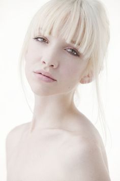 a woman with blonde hair is posing for the camera