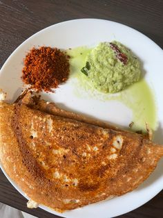 a white plate topped with food on top of a wooden table