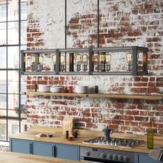 a kitchen with brick wall and wooden counter tops in front of a stove top oven