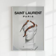 a book with a snake wrapped around it's head in front of a white wall