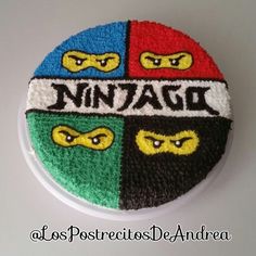 a cake decorated with ninja turtles and the word ninja written in four colors on it