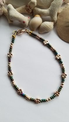 These green iris metallic beads really reflect a lot of different colours that was hard to capture in a picture. They colours are accented with some pretty round and flower shaped gold metal spacer beads. Approx 9" with lobster clasp. If you need additional length an extender chain can be added for no additional cost. Just add in Notes To Seller or convo me. Your anklet will last longer if you don't get it wet. ஐ ¸.**'¯) ஐ ¸.**'¯) ஐ ♥ All items handmade in beautiful Nova Scotia, Canada ♥ ** To c Nova Scotia Canada, Anklet Jewelry, Beach Summer, Nova Scotia, Handmade Design, Daisy Flower, Flower Shape, Spacer Beads, Body Jewelry