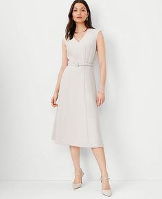 Elevate your wardrobe with the timeless elegance of Ann Taylor's Belted V-Neck Midi Dress in Fluid Crepe. This meticulously tailored piece, in a serene Ivory Whisper shade, is perfect for both office days and evening events.

- **Size:** 00 Regular
- **Color:** Ivory Whisper
- **Material:** 95% Polyester, 5% Spandex
- **Fit:** Tailored fit
- **Length:** Hits below the knee; approximately 30" from natural waist
- **Neckline:** Front and back V-neck
- **Sleeves:** Cap sleeves
- **Closure:** Hidden Midi Flare Dress, Knitted Suit, V Neck Midi Dress, Dresses Dresses, Feminine Dress, Ann Taylor Dresses, Petite Women, Midi Maxi Dress, Petite Outfits