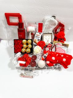 a basket filled with lots of red and white items on top of a table next to a clock