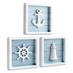 three white framed pictures with an anchor, lighthouse and ship wheel