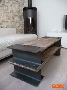 the table is made out of metal and wood, with an interesting design on it