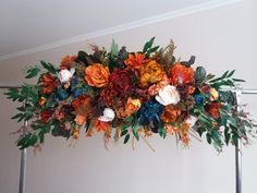 an arrangement of flowers hanging from the ceiling