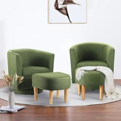 a living room with two green chairs and a footstool in front of a white wall