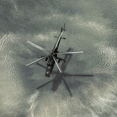 an aerial view of a helicopter in the water