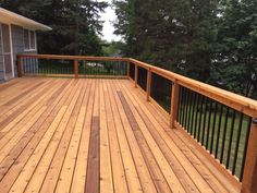 a wooden deck with black iron railings