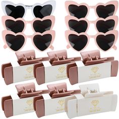 six pairs of heart shaped sunglasses in pink and white packaging with matching clippers for each pair