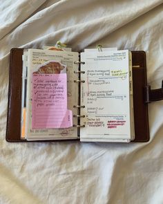 an open planner book on top of a bed