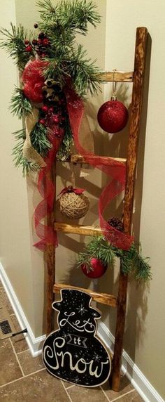 a ladder decorated with christmas ornaments and decorations