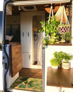 the interior of a camper van with plants in it