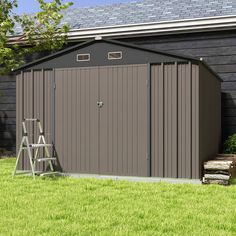 a small shed sitting on top of a lush green field