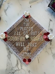 a decorated graduation cap that says oh the places i go but country roads will take me home