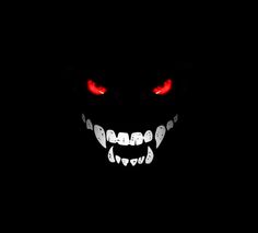 an evil face with glowing red eyes in the dark