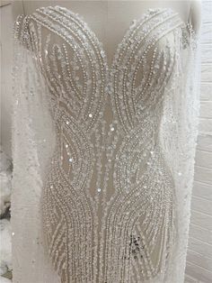 the back of a wedding dress with beading on it