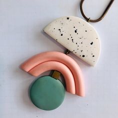 an assortment of ceramic items on a white surface with a brown cord hanging from it