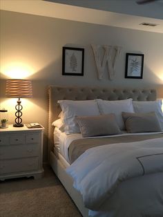 a large bed sitting in a bedroom next to two lamps on either side of it