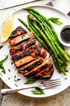 grilled chicken and asparagus on a white plate