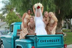 the bride and her bridesmaids are posing in the back of an old pickup truck