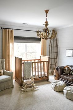 a baby's room with a crib, rocking chair and couch in it