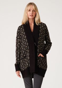 [Color: Black/Taupe] A front facing image of a blonde model wearing a cozy bohemian cardigan in a black and taupe geo jacquard design. With contrast ribbed trim Black Jacquard Knit Cardigan For Fall, Fall Jacquard Knit Cardigan For Layering, Black Jacquard Knit Outerwear For Fall, Black Jacquard Knit Long Sleeve Outerwear, Elegant Jacquard Knit Winter Outerwear, Fall Workwear Jacquard Knit Cardigan, Fall Jacquard Knit Cardigan For Work, Fall Cardigan For Cold Weather With Jacquard Knit, Elegant Jacquard Knit Outerwear For Winter