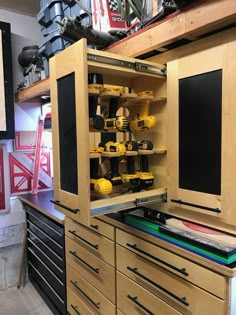 a workbench with lots of tools in it and some shelves on the wall