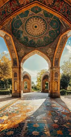 an intricately decorated walkway in the middle of a park with many arches and pillars