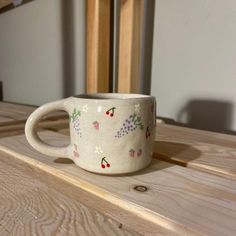 a coffee cup sitting on top of a wooden table