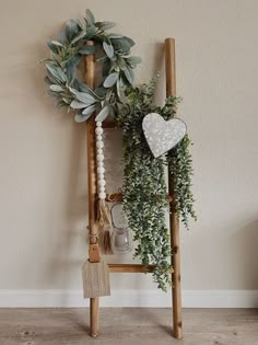 a wooden ladder holding a wreath and other items