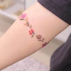 a woman with a flower tattoo on her arm