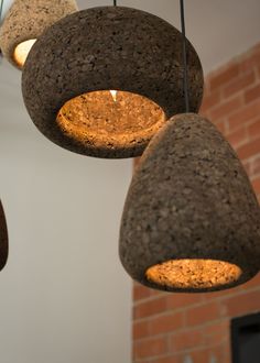 three stone lamps hanging from the ceiling