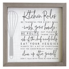 a kitchen rules print in a frame with a whisk on the wall behind it