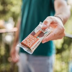 a person holding a bar of chocolate in their hand