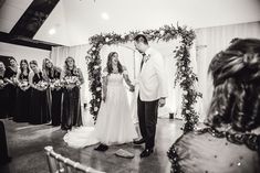 a bride and groom hold hands at their wedding ceremony