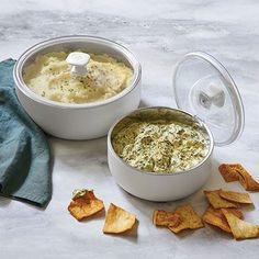 two white bowls filled with dip and chips