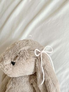 a stuffed animal sitting on top of a bed