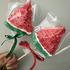 two watermelon lollipops wrapped in plastic wrappers