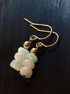 Handmade natural Fire Opal earrings, gemstone dangles, gold hooks, petite jewelry. Genuine stones are opaque, about 4 - 6 mm, flushing with colorful hues of yellow, pink, green, orange. These earrings look beautiful, better than on photos. Perfect for those who are born in October. French hooks are handmade with 12k gold fill wires. You will get similar to the photos earrings. Each pair of eatings is unique and one of a kind. I can send you some photos of the stones I have on hand if you are int 14k Gold Filled Yellow Gold Earrings With Natural Stones, 14k Yellow Gold Earrings With Natural Stones, Gold Opal Drop Earrings, Handmade Opal Drop Earrings, Teardrop Opal Earrings In Gold, Opal Gemstone Drop Earrings, 14k Gold-filled Yellow Gold Earrings With Natural Stones, Minimalist 14k Gold-filled Earrings With Natural Stones, Born In October