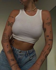 a woman with tattoos on her arms and chest